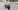 Parent walking through parking log carrying infant in car seat