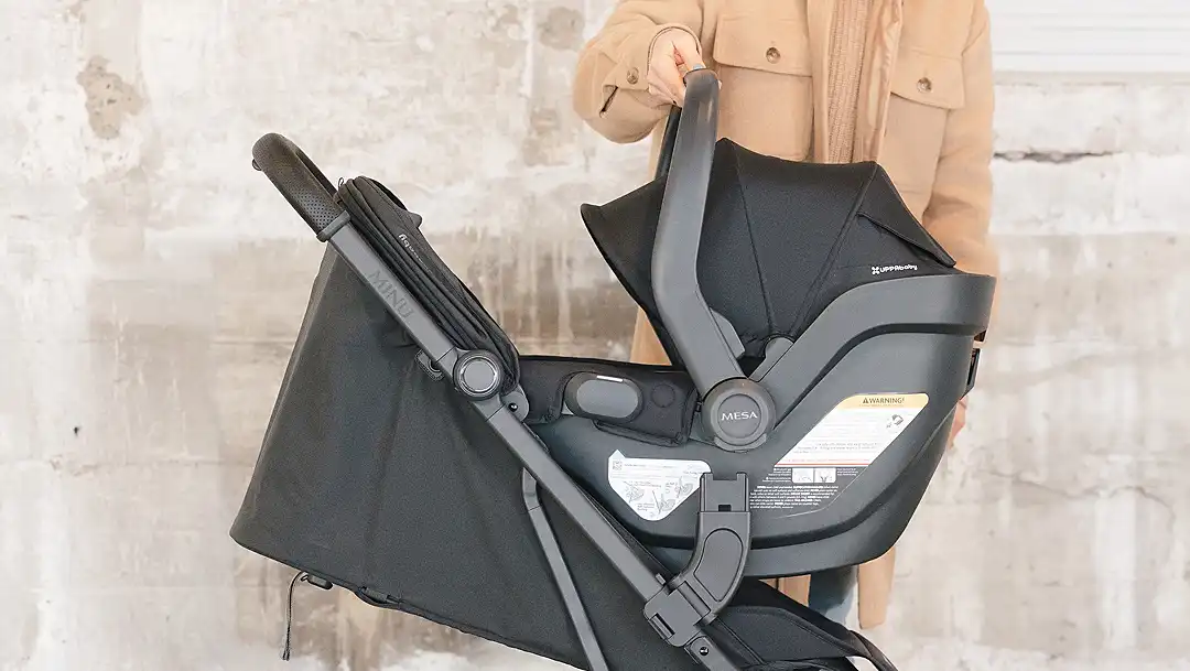 Parent using travel system