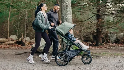 Family walking in the woods with stroller