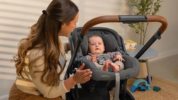 Mother with child in an UPPAbaby car seat